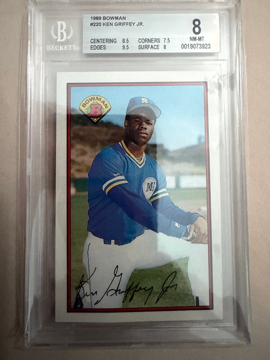Trading card of a baseball player in a blue uniform with a signature, encased in clear plastic.