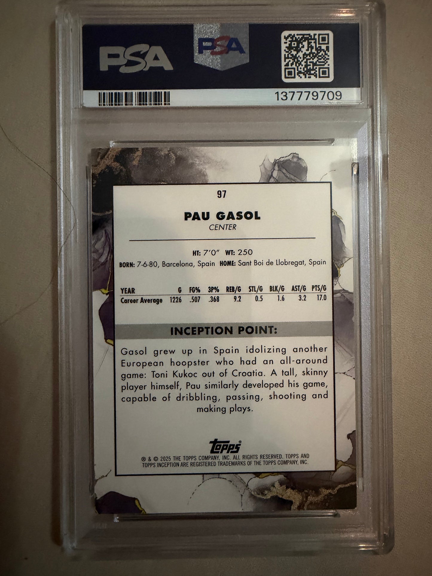 Trading card of Pañó Gasol with PSA grading information on a beige background